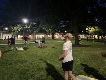 Brothers play cornhole at chapter house