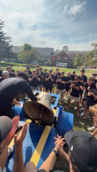 Epsilon Kappa's newest members ring Ol Alpha on Bid day