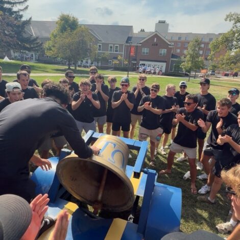 Epsilon Kappa's newest members ring Ol Alpha on Bid day